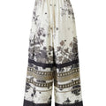 Black and white silk-effect pants with delicate Chinese-inspired print, fluid silhouette and minimalist monochrome design.