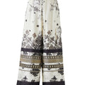 Black and white silk-effect pants with delicate Chinese-inspired print, fluid silhouette and minimalist monochrome design.