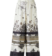 Black and white silk-effect pants with delicate Chinese-inspired print, fluid silhouette and minimalist monochrome design.