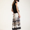 Black and white silk-effect pants with delicate Chinese-inspired print, fluid silhouette and minimalist monochrome design.