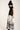 Black and white silk-effect pants with delicate Chinese-inspired print, fluid silhouette and minimalist monochrome design.