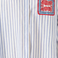 Women's blue and white striped cotton shirt with intricate Miao embroidery, contemporary design inspired by traditional craftsmanship.