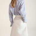 Women's blue and white striped cotton shirt with intricate Miao embroidery, contemporary design inspired by traditional craftsmanship.