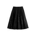 Hui Milano black bud-shaped skirt with pleats and delicate floral embroidery, refined and feminine design, versatile for sophisticated outfits, front view on white background.