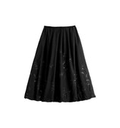 Hui Milano black bud-shaped skirt with pleats and delicate floral embroidery, refined and feminine design, versatile for sophisticated outfits, front view on white background.