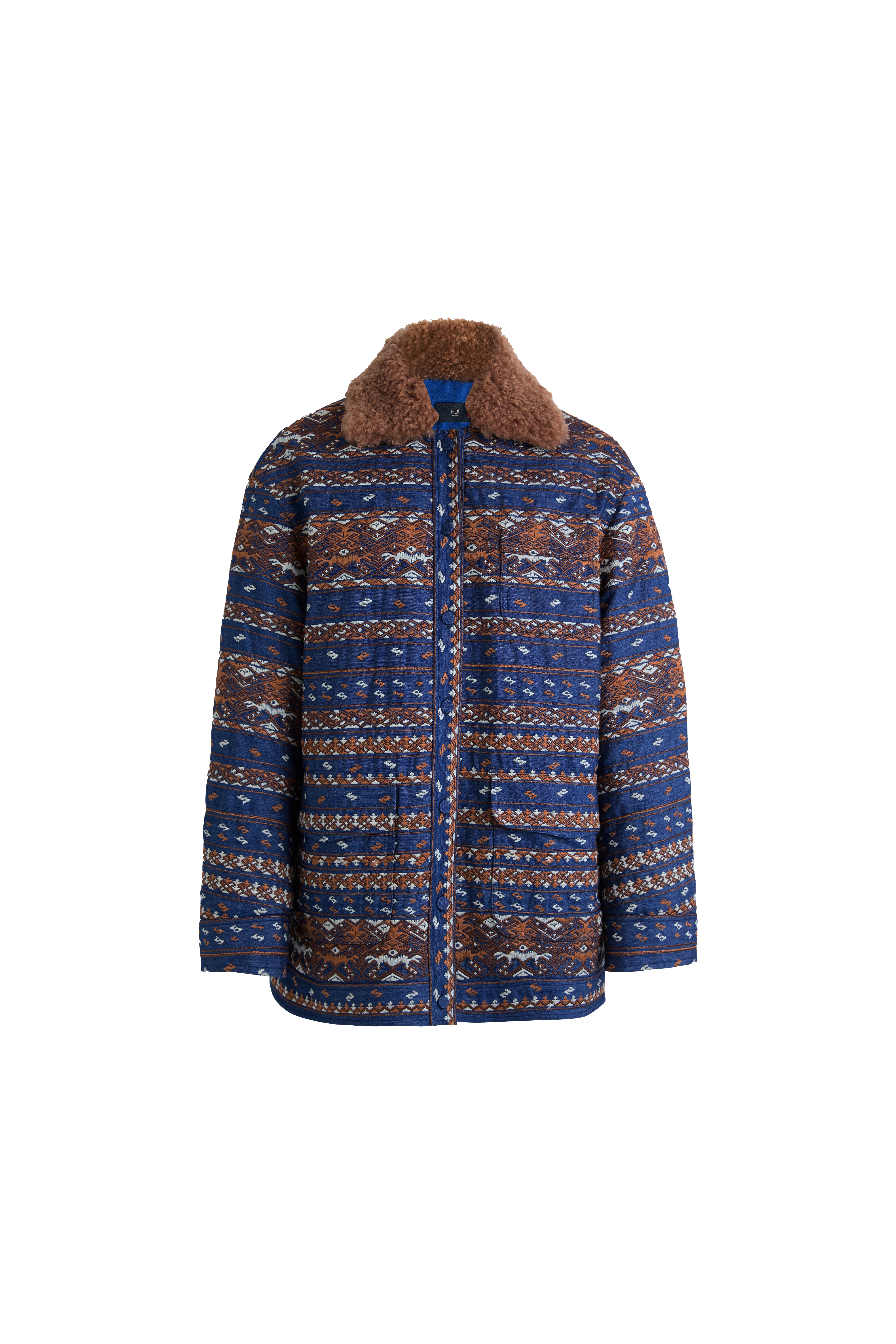 Hui Milano blue padded denim jacket with full Miao-inspired embroidery, fur collar, and padded interior, blending cultural heritage with modern denim style, warm and distinctive design, front view on white background.