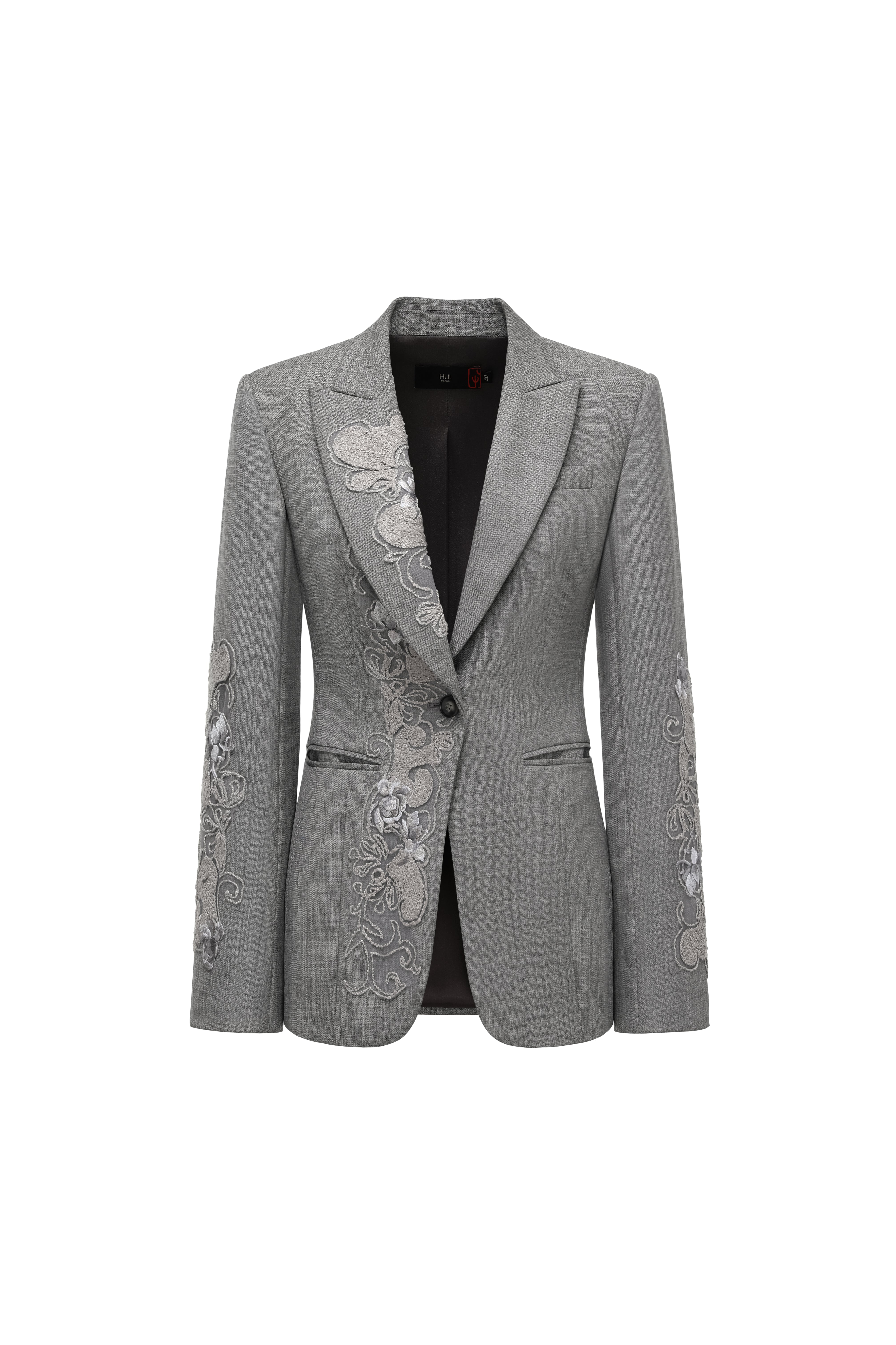 Hui Milano grey wool jacket with classic notched lapel, single-button closure, left chest pocket, and delicate white embroidery on sleeves and front, elegant and structured design for formal or semi-formal occasions, front view on white background.
