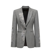 Hui Milano grey wool jacket with classic notched lapel, single-button closure, left chest pocket, and delicate white embroidery on sleeves and front, elegant and structured design for formal or semi-formal occasions, front view on white background.