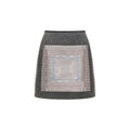 Hui Milano light grey short A-line skirt with square front decoration and geometric Miao embroidery, wool-polyamide blend for comfort and structure, elegant and versatile design, front view on white background.