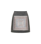 Hui Milano light grey short A-line skirt with square front decoration and geometric Miao embroidery, wool-polyamide blend for comfort and structure, elegant and versatile design, front view on white background.