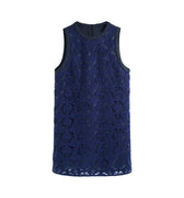 Hui Milano sleeveless navy blue A-line dress in raised floral lace with black nylon inserts on neckline and armholes, elegant and versatile design blending timeless sophistication with modern material contrast, front view on white background.