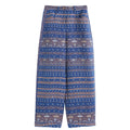 Hui Milano wide-leg blue pants with intricate jacquard Miao ethnic motifs, buttoned waistband, relaxed fit for comfort, elegant and culturally inspired design, front view on white background.