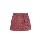 Hui Milano Xiangyun short cotton skirt in silk-cotton blend with diamond stitching, front zipper closure, asymmetrical design, elegant yet playful style for sophisticated winter outfits, front view on white background.