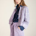 Purple sequin coat with wave-inspired ruffle details and traditional Chinese stand collar, elegant outerwear blending cultural heritage with modern sophistication.
