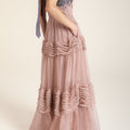 Muted pink wave dress with soft cascading layers, fluid silhouette inspired by water movement, feminine and serene design.