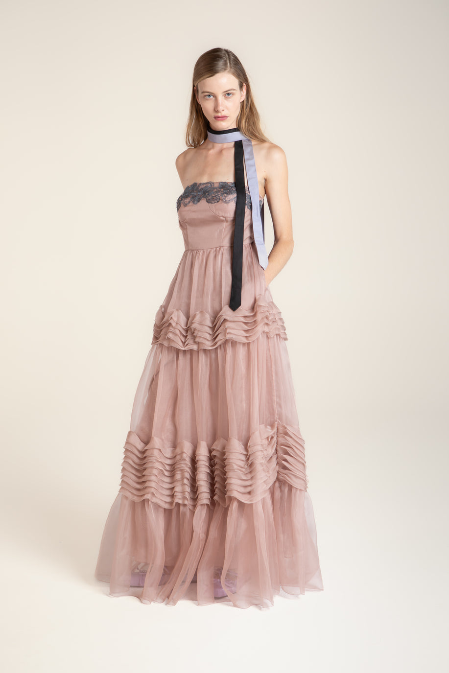 Muted pink wave dress with soft cascading layers, fluid silhouette inspired by water movement, feminine and serene design.