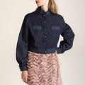 Flowing midi-length wavy skirt with wave-like ruffle trim and delicate embroidery, modern design inspired by Chinese heritage.